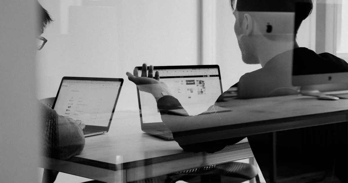 Store operator comparing app roles on a notepad beside a laptop

---

# content