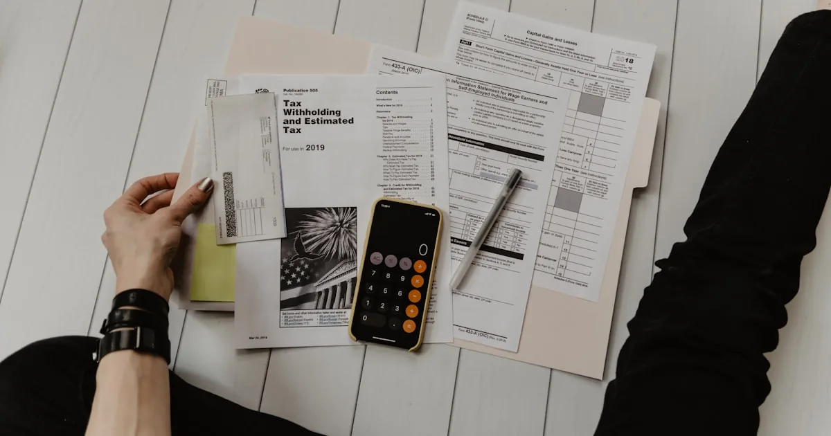 Calculator and printed figures on a desk, used for a Shopify plan and fee comparison

---

# content