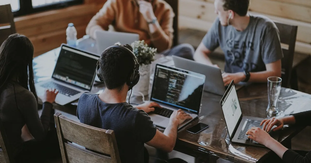 Two colleagues comparing notes at a laptop, used for a Shopify versus WooCommerce decision

---

# content
